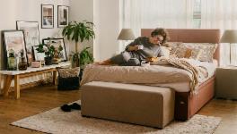 Woman sitting on bed and reading a book