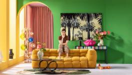 Woman sitting on a yellow couch in living room