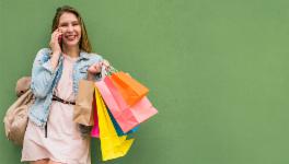 Woman carrying shopping bags with  smile on her face