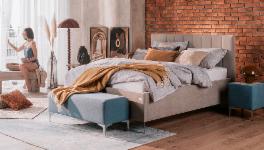 Two modern bedrooms with beds, plants and warm lighting