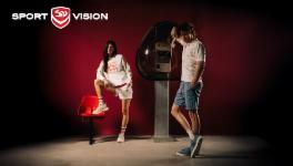 Young man and woman in sportswear in front of a retro phone booth