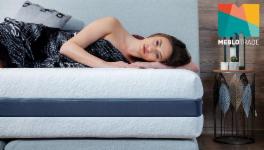 A woman lies on a mattress