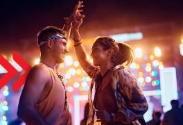 A man and a woman are dancing at a concert